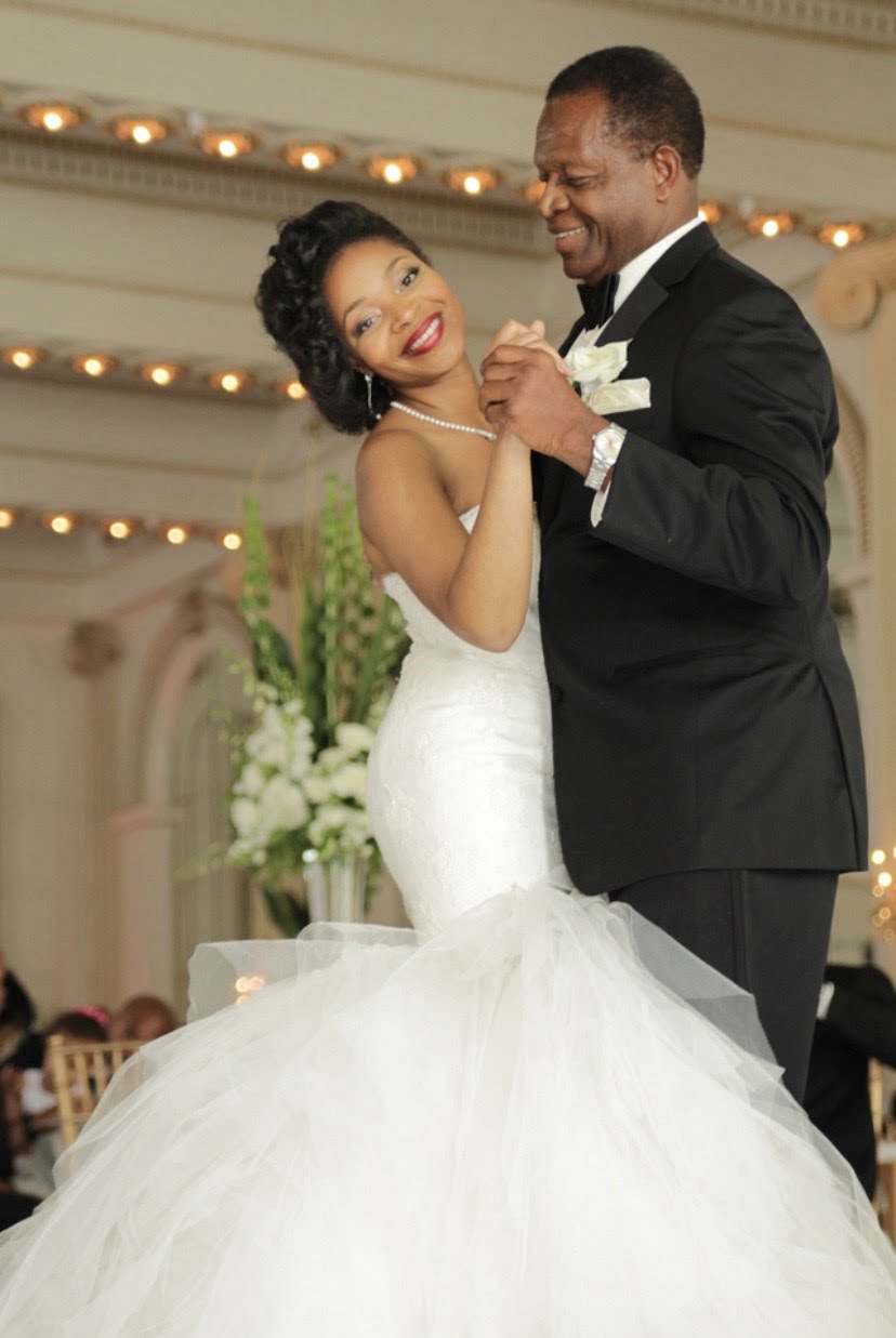 Photo of beautiful bride and father dancing at wedding reception