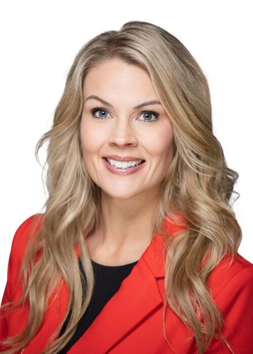 Professional headshot for business of realtor Erika Adornetto in red jacket