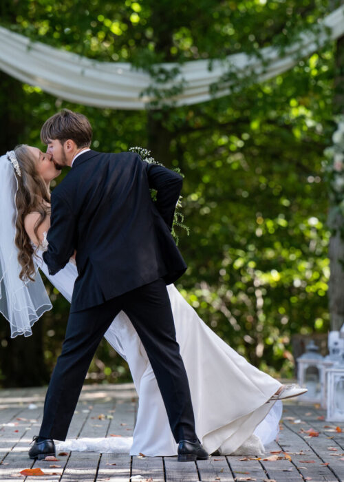 Beautiful image of wedding couple with romatic kiss