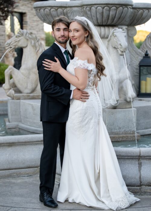 Beautiful image of wedding couple with fountain behind