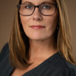 Gallery image of Professional headshot of intelligent female executive