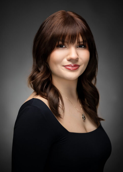 Professional headshot of attractive brown haired woman