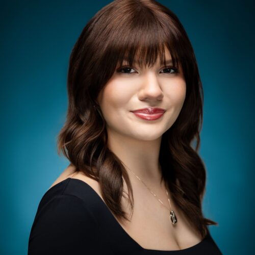 Professional headshot of stunning dark haired woman with pretty face