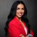 Gallery image of Professional headshot of of attractive business woman in red blazer