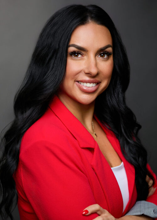 Professional headshot of of attractive business woman in red blazer